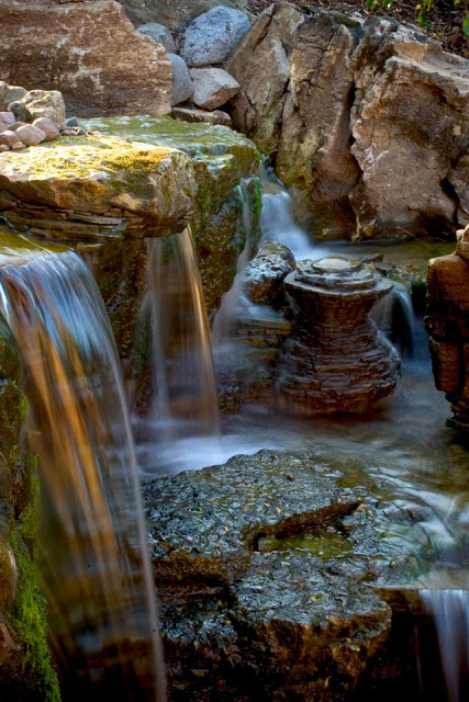 By the looks of the moss and worn appearance of the rocks, you'd never know this is a new backyard waterfall. 