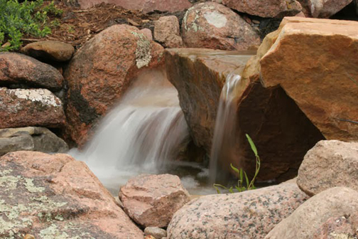 Rocks lend an architectural element to a waterfall and should be chosen carefully. Often, a pond installer will re-position a boulder several times until the right look is achieved.
